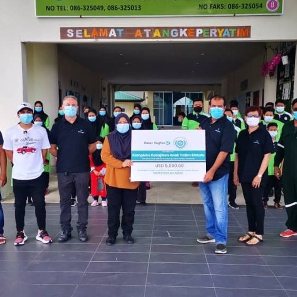 employees holding big check poster