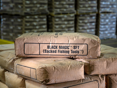 Photo of bags of BLACK MAGIC spotting fluids in the warehouse.