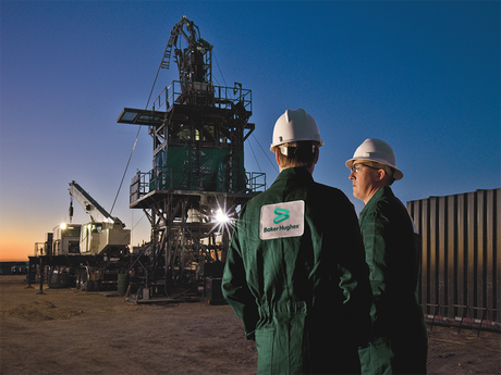 Two Baker Hughes employees at a coiled-tubing rig site