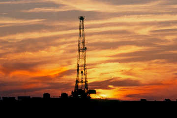 Photo of a land rig at sunset.