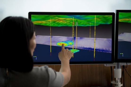 一个女人在触摸屏上分析地震数据