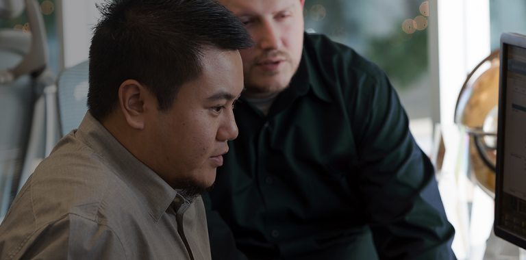 Employees looking at computer screen