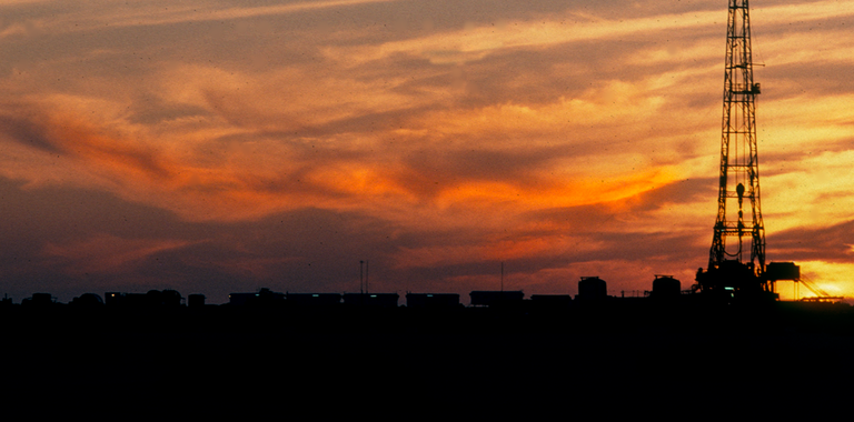 Photo of a land rig at sunset.